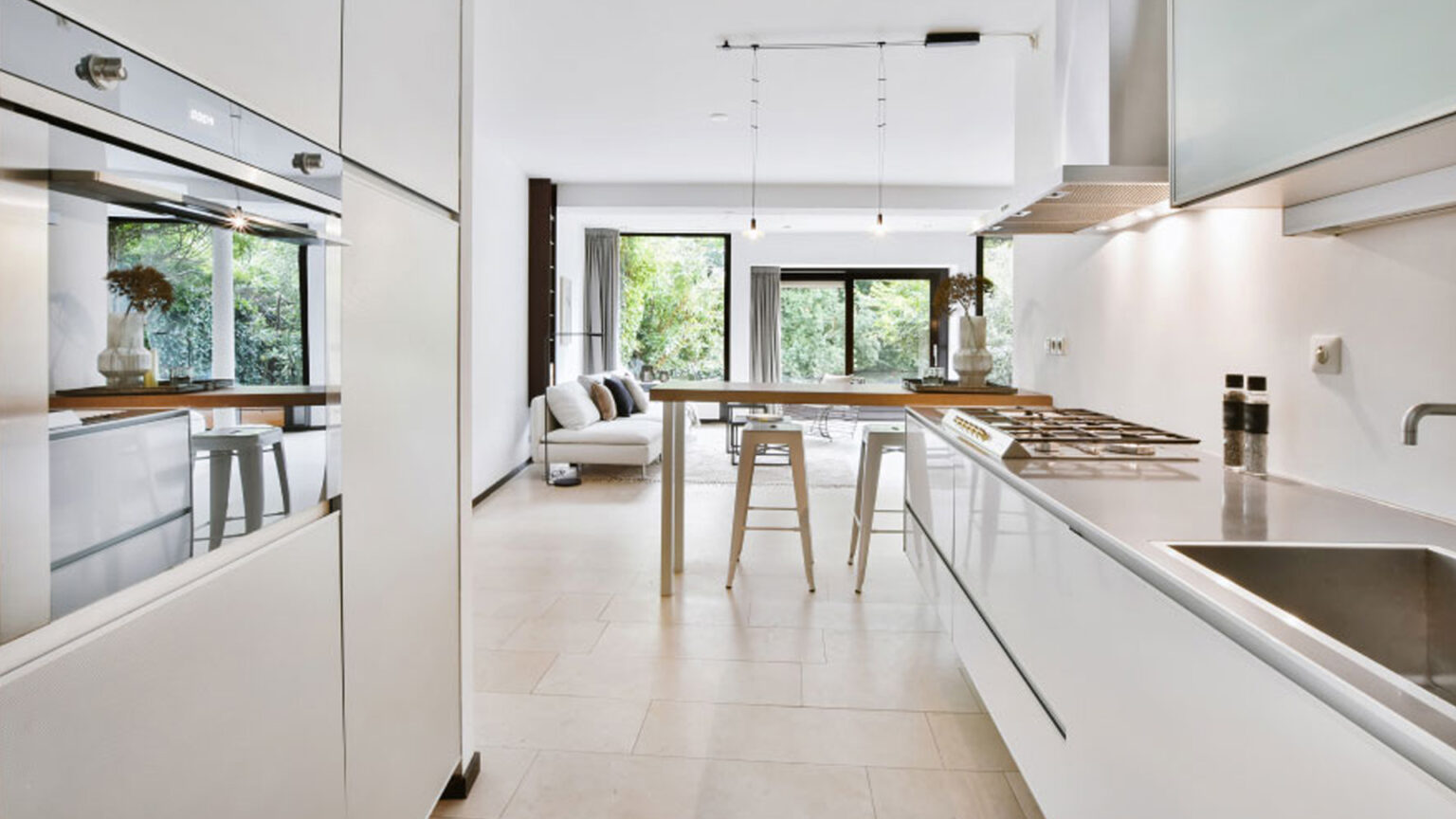 Modern kitchen remodel in Austin with white cabinets and islan
